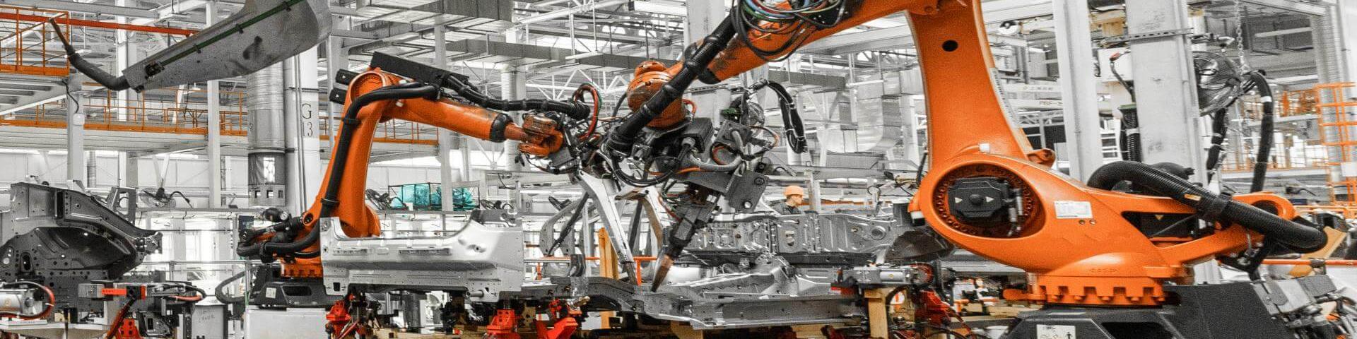 Automobile production line. Welding robots at work